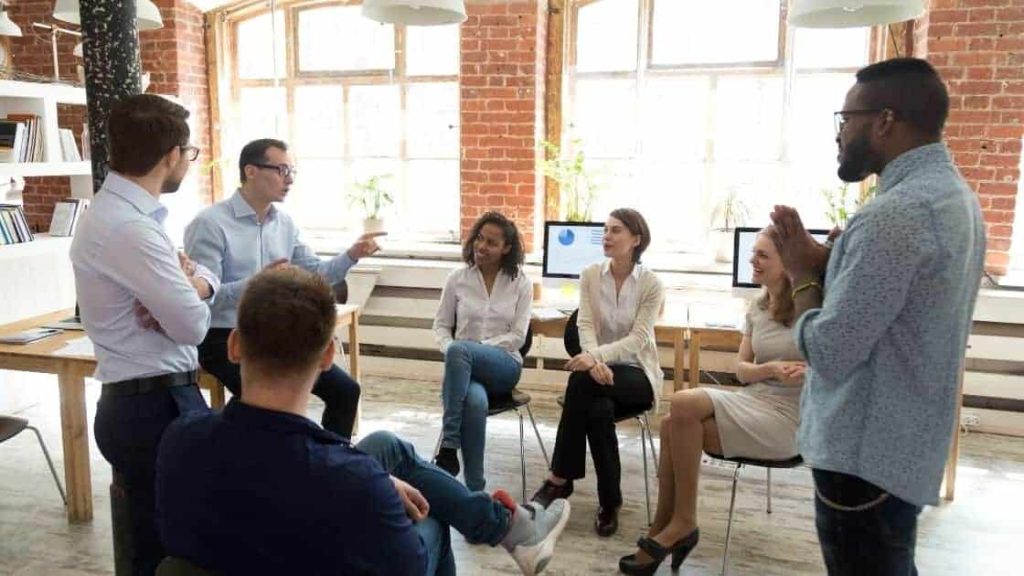 A small business owner meeting with their team to encourage think differently business ideas.