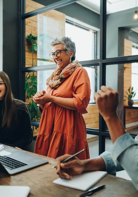 diverse businesspeople smiling cheerfully during an office meeting